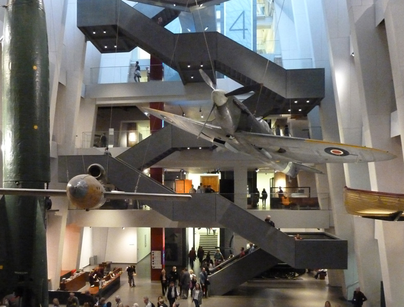 The view through the atrium towards the cantilever stairs and the Spitfire .